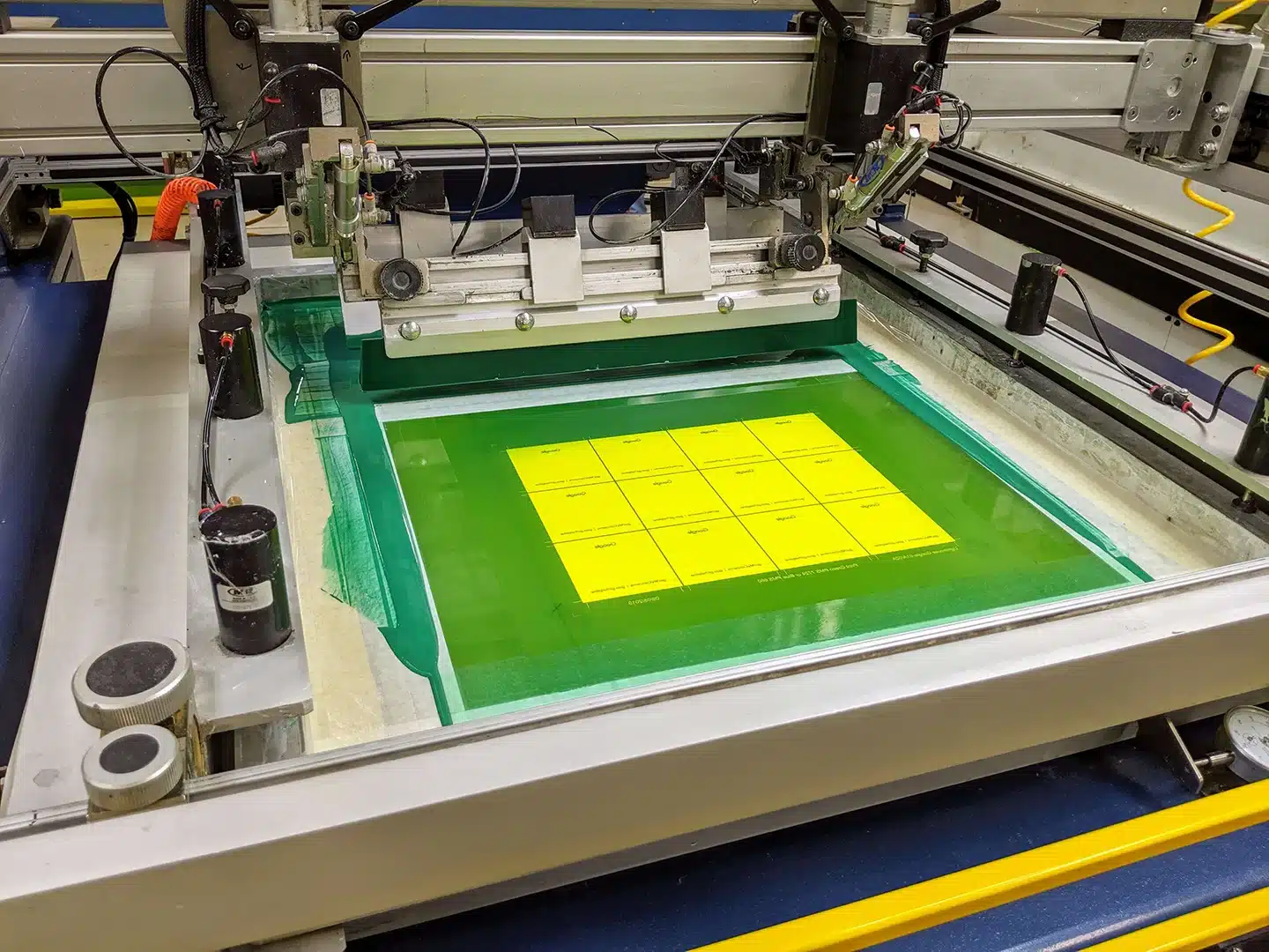 overhead view of screen printer printing keypad decals