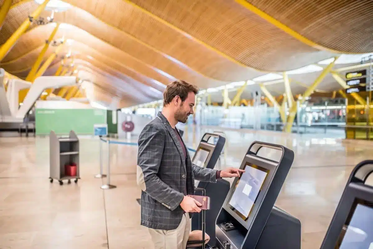 kioskuser man standing at a kiosk in an airport terminal